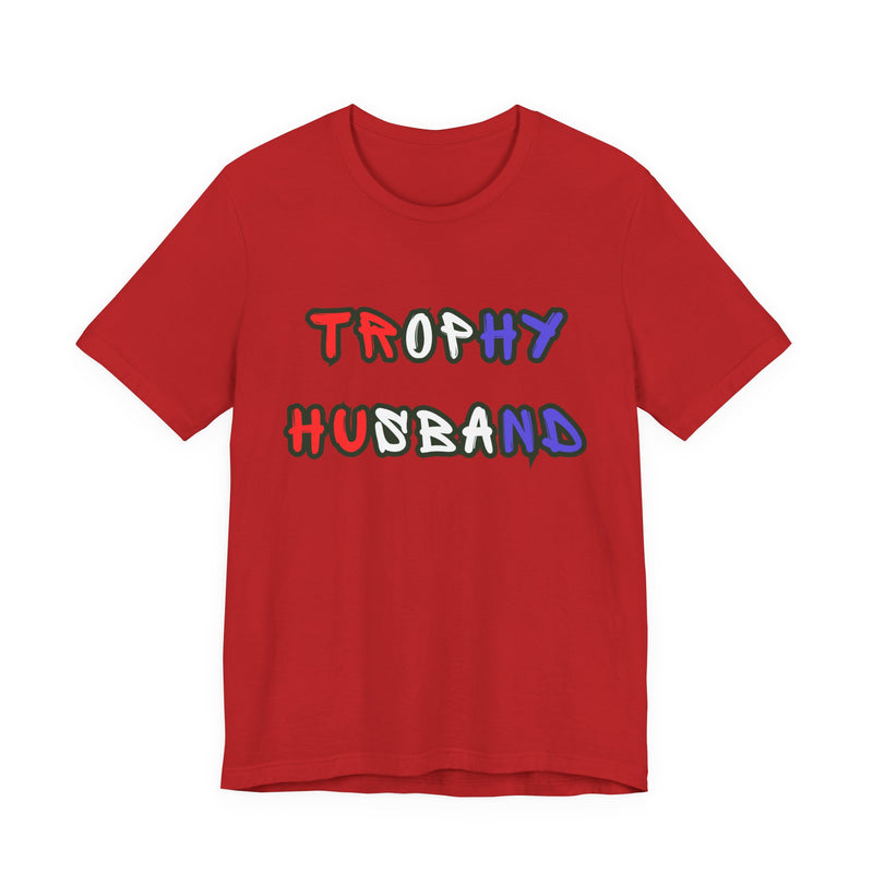 Red t-shirt with 'Trophy Husband' in red white and blue text on a white background