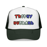 Green Trucker hat with 'Trophy Husband' in red white and blue text, standing against a white background
