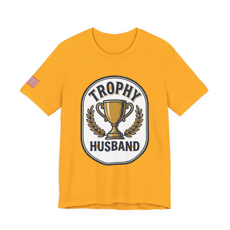 Yellow t-shirt with 'Trophy Husband' graphic design on a white background