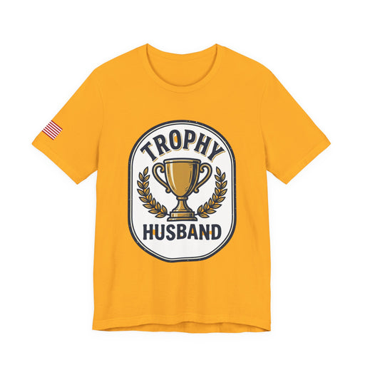 Yellow t-shirt with 'Trophy Husband' graphic design on a white background