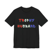 Black t-shirt with 'Trophy Husband' in red white and blue text on a white background