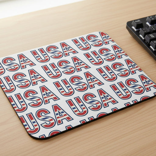 Mouse pad with 'USA' text in red and blue on a desk.
