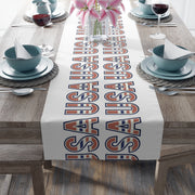 USA themed table runner displayed from the head of the table with plates, and glasses.