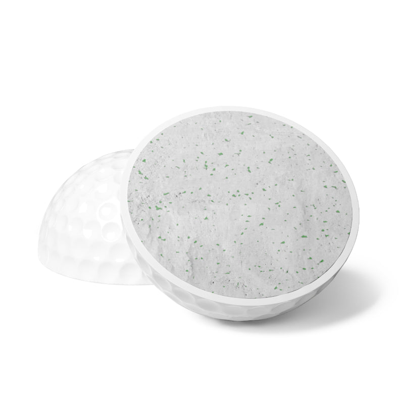 Customizable white golf balls with a "your design or words" placeholder cut in half to see the core on a white background.