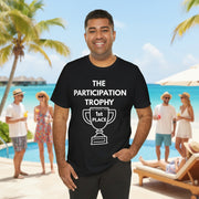 Man wearing a black t-shirt with 'The Participation Trophy 1st Place' white text and white graphic in front of pool. 