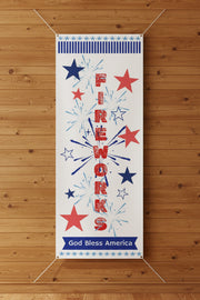 Patriotic vertical matte banner with red white and blue stars, fireworks and the word fireworks 36x96 inches on an indoor wall.