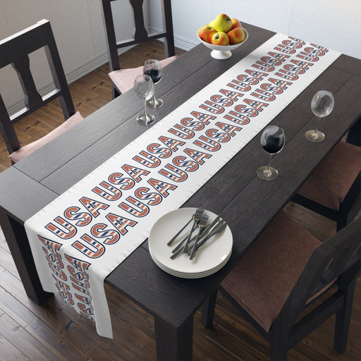 USA themed table runner on a dining room table with plates, and glasses.