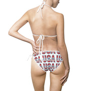 oman wearing a red, white, and blue 'USA' patterned bikini on a white background with white biking strings pictured from the back.
