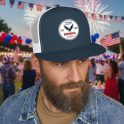 Man wearing a navy blue and white flat bill trucker cap with a logo 'celebrating America 250 years' displayed in front of a party. 