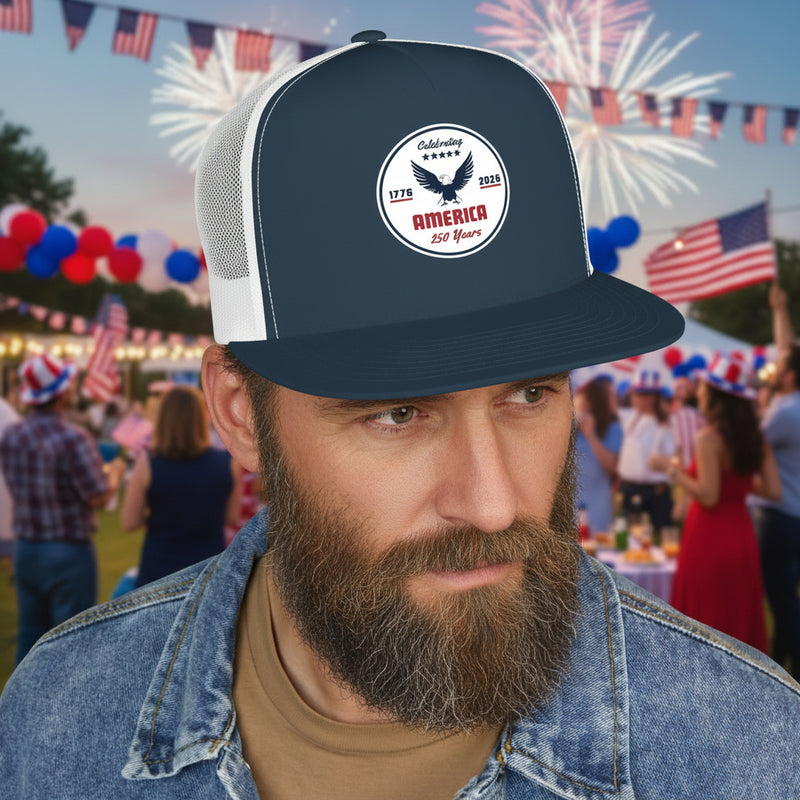 Man wearing a navy blue and white flat bill trucker cap with a logo 'celebrating America 250 years' displayed in front of a party. 