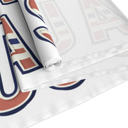 Table runner close up and folded with 'USA' in red white and blue repeated on a white background. 