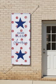 Patriotic “God Bless America” vertical matte banner with red polka dot background hanging on back of house, 36x96 inches.