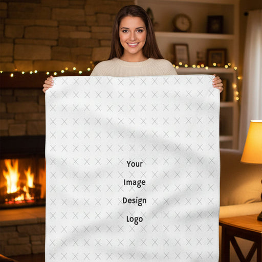 Customizable sherpa fleece blanket with "your image or design" placeholder displayed by a woman in a cozy house.
