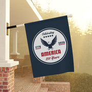 Decorative flag celebrating America's 250th anniversary hanging on a porch.