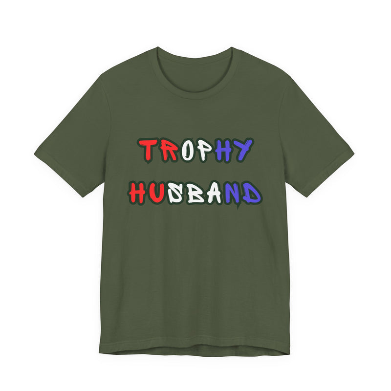 Green t-shirt with 'Trophy Husband' in red white and blue text  on a white background