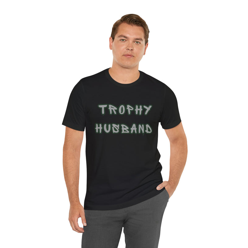 Man wearing a black t-shirt with "Trophy Husband" graphic.