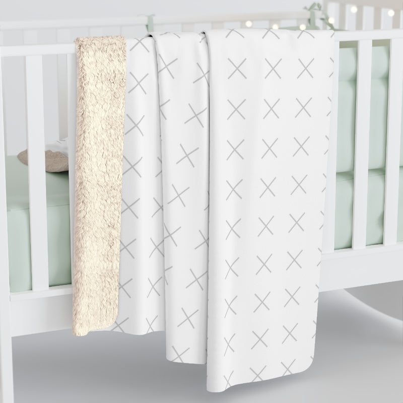 Customizable sherpa fleece blanket with "your image or design" placeholder laying on a crib. 