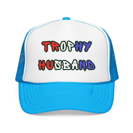 Bright blue Trucker hat with 'Trophy Husband' in red white and blue text, standing against a white background