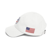 Side of all white classic ball cap with a circular emblem featuring an eagle and text , along with the American flag on the side on a white background.