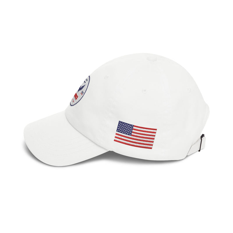 Side of all white classic ball cap with a circular emblem featuring an eagle and text , along with the American flag on the side on a white background.