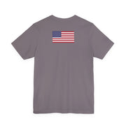 Back of a gray t-shirt with American flag on the back against a white background