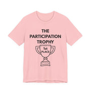 Pink t-shirt with 'The Participation Trophy 1st Place' text and graphic on a white background