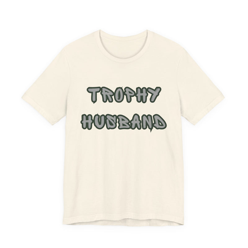 Beige t-shirt with 'Trophy Husband' text on a white background