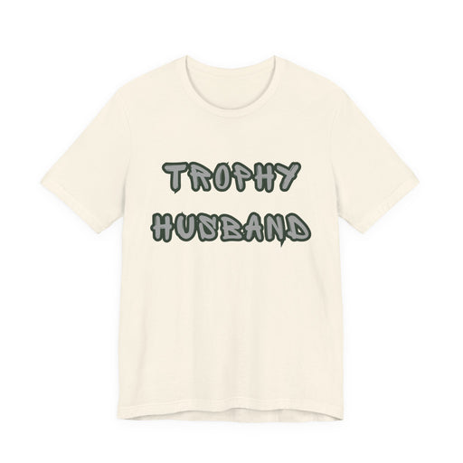 Beige t-shirt with 'Trophy Husband' text on a white background