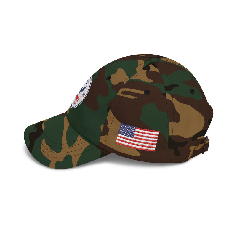 Side of camouflage classic ball cap with a circular emblem featuring an eagle and text , along with the American flag on the side on a white background.
