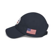 Side of all Navy blue classic ball cap with a circular emblem featuring an eagle and text , along with the American flag on the side on a white background.