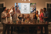 Custom matte photo banner with two family photos and center panel for name, age, and date hanging above a party table, 48x24 and 72x36 inches.