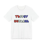 White t-shirt with 'Trophy Husband' in red white and blue text on a white background