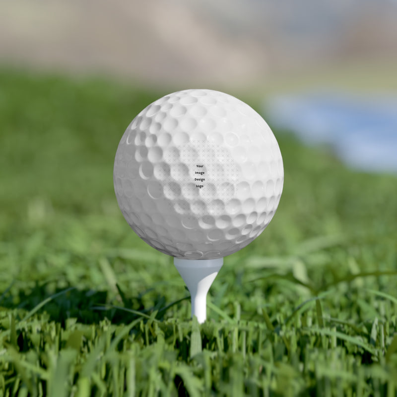 Customizable white golf balls with a "your design or words" placeholder on a tee on grass.