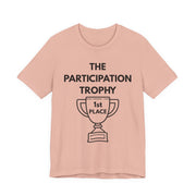 Pink t-shirt with 'The Participation Trophy 1st Place' text and graphic on a white background