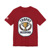 Red t-shirt with 'Trophy Husband' graphic on a white background