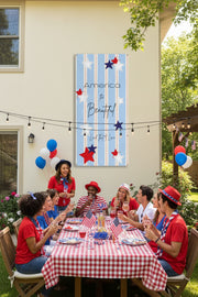 Patriotic vertical vinyl banner 24x48 and 36x72 inches with strips and red white and blue stars on back of house at a party.