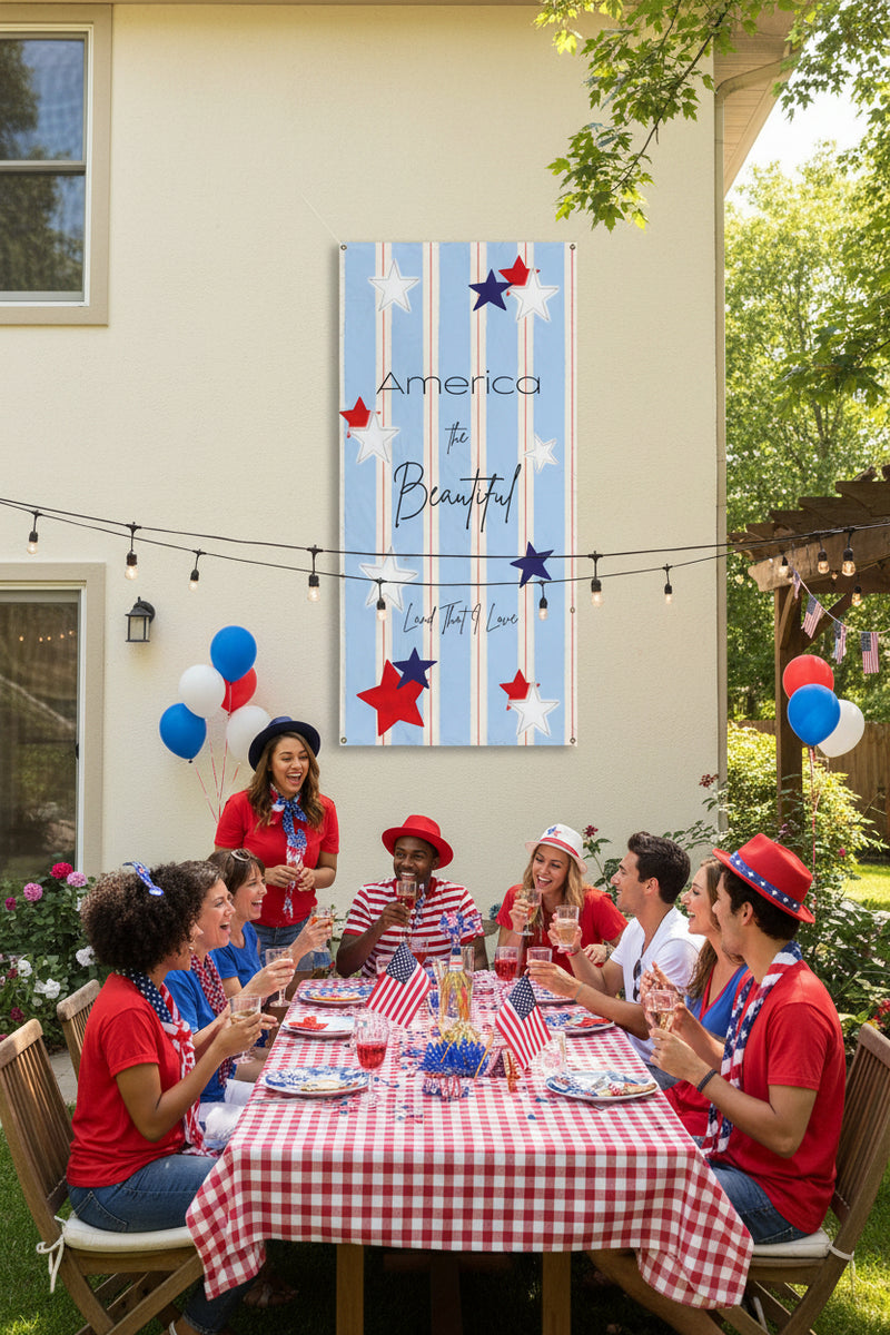 Patriotic vertical vinyl banner 24x48 and 36x72 inches with strips and red white and blue stars on back of house at a party.