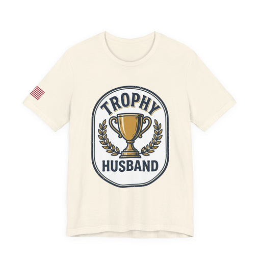 Natural color t-shirt with 'Trophy Husband' graphic design on a white background