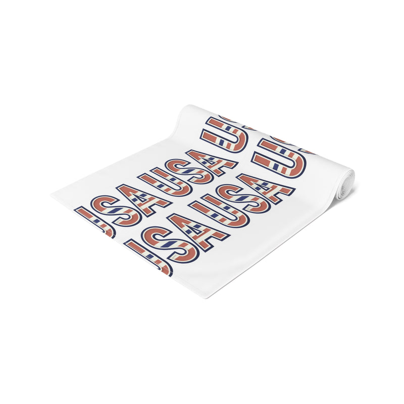 USA themed table runner partially rolled up on a white background.
