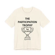 Beige t-shirt with 'The Participation Trophy 1st Place' text and graphic on a white background