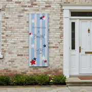 Patriotic matte banner 36x96 with strips and red white and blue stars hanging next to front door.