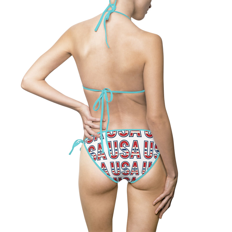 oman wearing a red, white, and blue 'USA' patterned bikini on a white background with mint green biking strings pictured from the back.