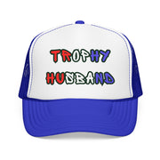 Blue Trucker hat with 'Trophy Husband' in red white and blue text, against a white background