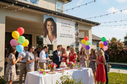 Custom matte photo banner with large portrait, three smaller photos, and space for name and special message hanging above a party table, 96x60 inches.