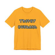 Yellow t-shirt with 'Trophy Husband' text on a white background