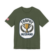 Green t-shirt with 'Trophy Husband' graphic on a white background