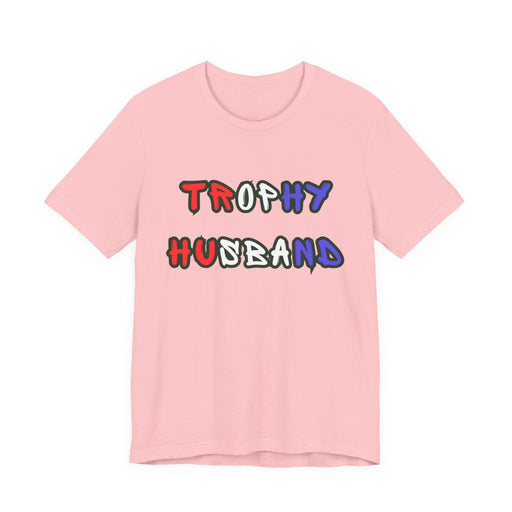 Pink t-shirt with 'Trophy Husband' in red white and blue text on a white background