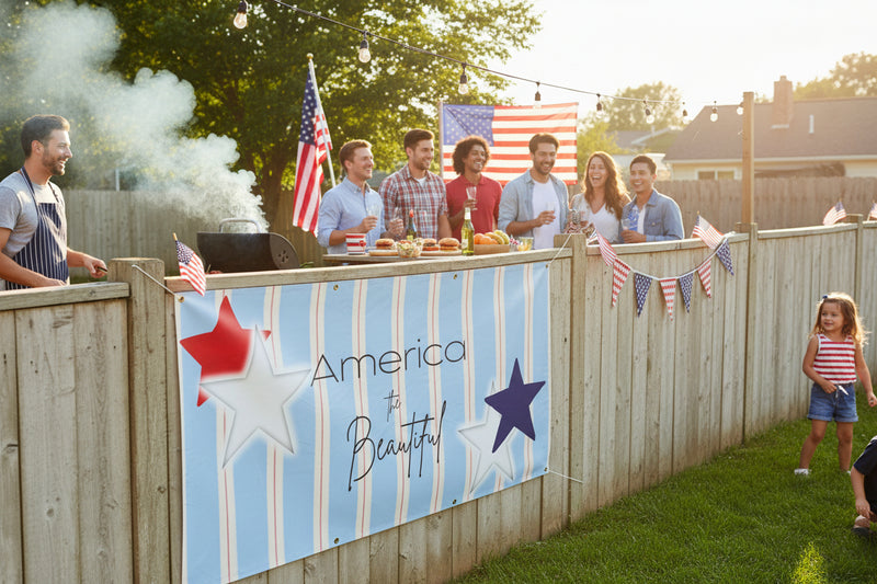 Patriotic “America the Beautiful” vinyl banner with blue stripes and red and blue stars hanging on fence at a party, 48x24 and 72x36 inches.