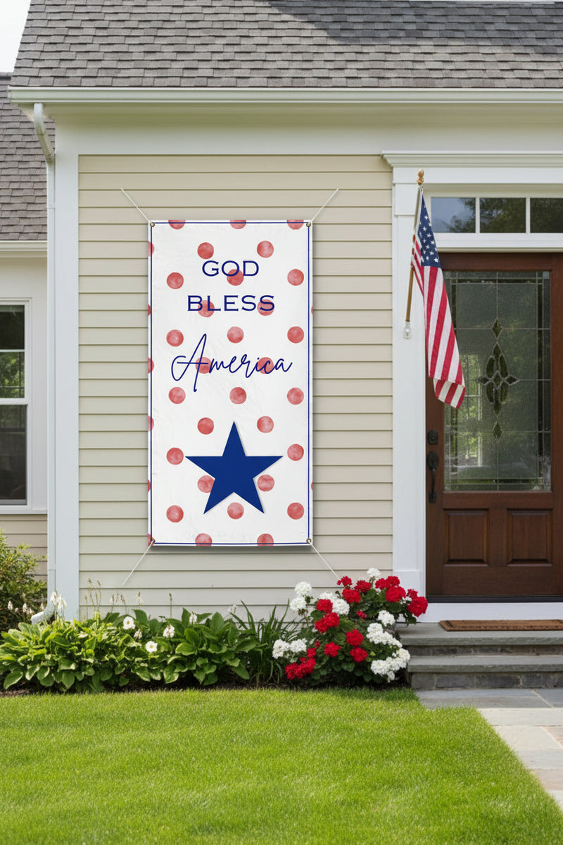 Patriotic “God Bless America” vinyl banner with red polka dot background, 36x72 and 24x48 inches on front of house.