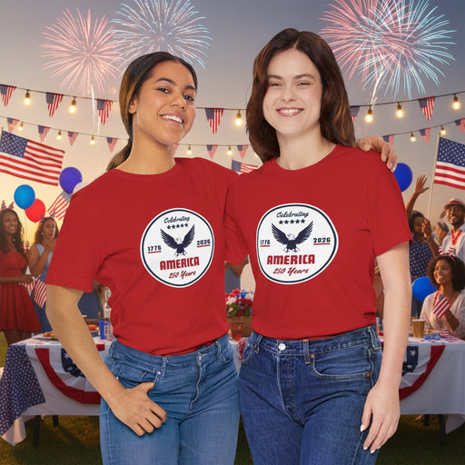 Two people wearing red t-shirts with a 'Celebrating America 250 Years' design  displayed in front of a party.